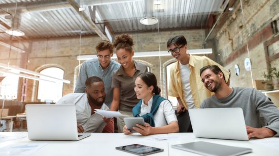 young people smiling in a team meeting