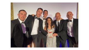 a group of 5 men and one woman at an awards ceremony