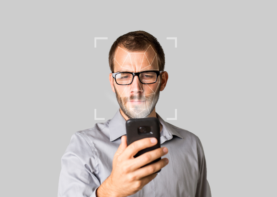 Man using facial scanning app on phone