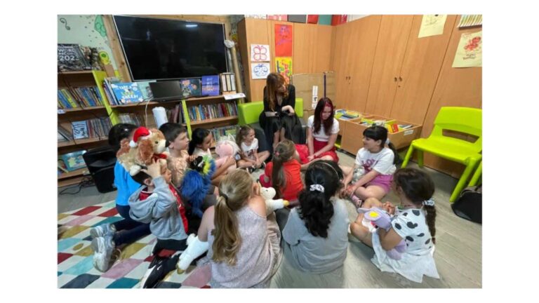 Be Free Campaign image shows a group of children gathered around, sitting on the floor in a learning environment
