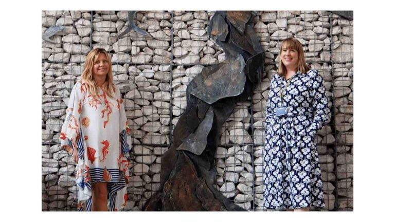 Two females stoor in front of Clatterbridge cancer centre sculpture