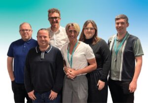 A group of Medicash employees stood up and smiling